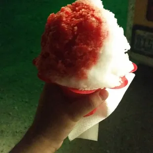 a hand holding a piece of ice cream