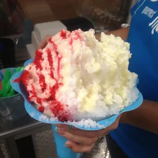 a person holding a large piece of cake