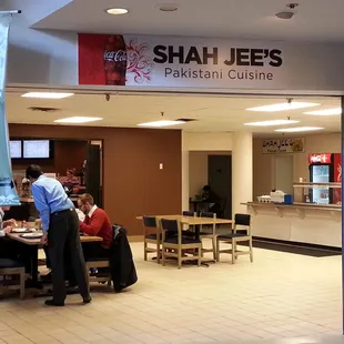 people sitting at tables in a restaurant