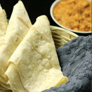 a plate of flatbreads and a bowl of dip