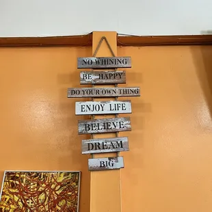 a wooden sign with different signs attached to it