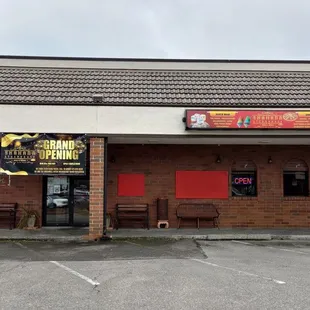 The outside does not clearly state the name yet as of Feb 2022. The entrance is right below the gold &apos;grand opening&apos; sign.