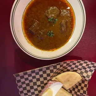 a bowl of soup and pita bread