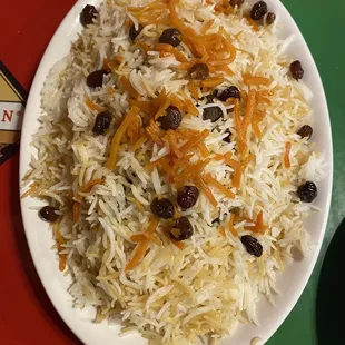 Kabuli Pulao - Rice, raisins &amp; carrot chutes on top of a big lamb shank
