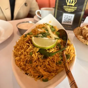 a plate of rice with lime wedges