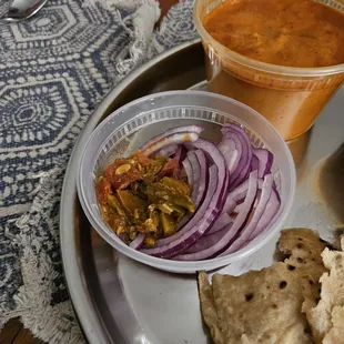 They give onions and pickle with curries. Love the pickle! I wish tikka masala was as good as butter chicken though!