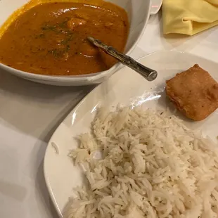 a plate of rice and a bowl of curry