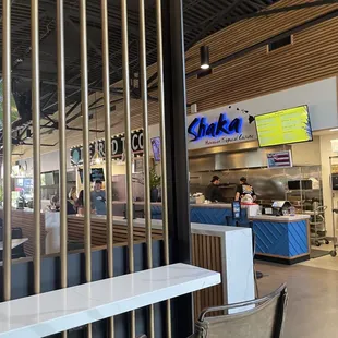 the interior of a restaurant with tables and chairs