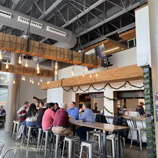 people sitting at tables in a restaurant