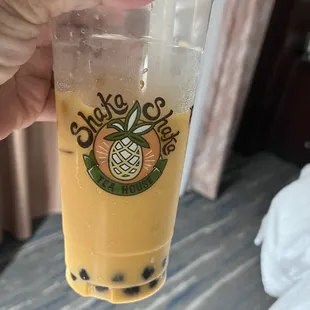 a hand holding a cup of tea