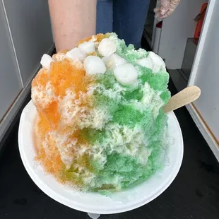a woman holding a plate of ice cream
