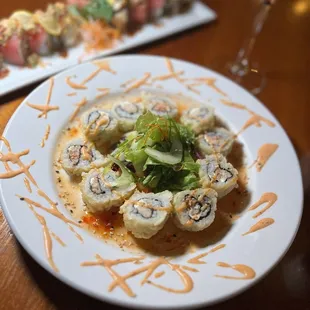 a plate of sushi and a glass of wine
