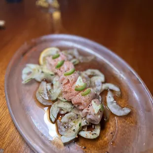 a plate of sushi on a wooden table