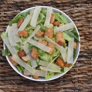 ows a bowl of lettuce and croutons