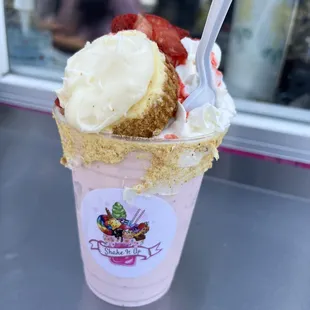 a cup of ice cream and strawberries