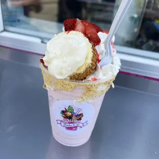 a strawberry shortcake with whipped cream and strawberries