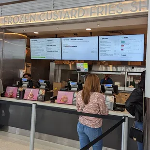 a woman standing in front of the counter