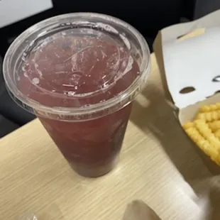 a drink and fries on a table