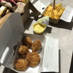 Checked bites and fries with cheese sauce