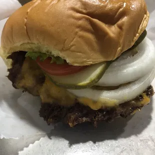 Single burger with cheese, lettuce, tomato, onion