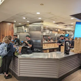 a group of people standing around a counter