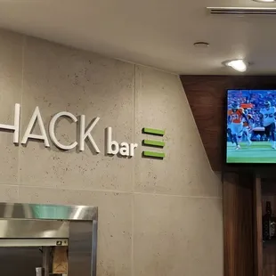 a bar with a television and a bar counter