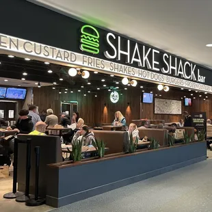 people sitting at tables in a restaurant