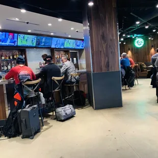 a group of people sitting at a bar