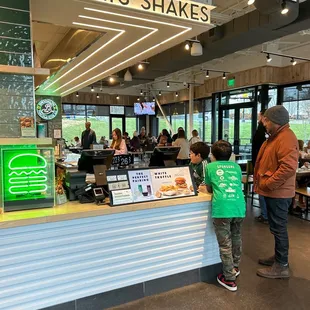 a man and a child standing in front of the counter