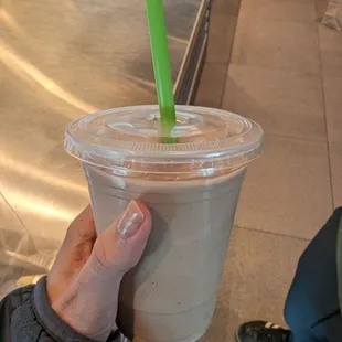 a hand holding a drink