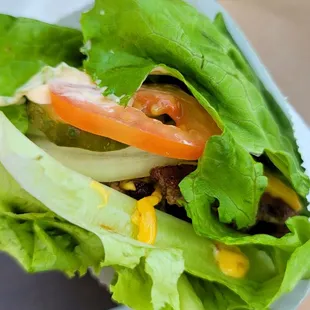 Double Shake Shack cheese burger / bacon, tomatoes, pickles and onions in a Lettuce wrap