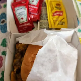 Cheeseburger without their mayo based sauce and packets of mustard and ketchup