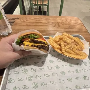 a tray of fries and a cheeseburger