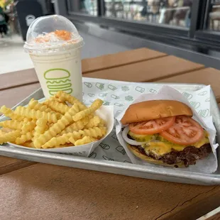Cheeseburger, fries, and peach milkshake