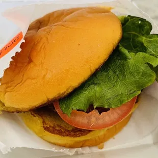 a hamburger with lettuce and tomato