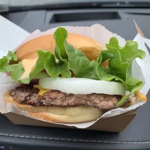 a hamburger with lettuce and onions