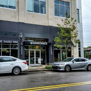 two cars parked in front of a building