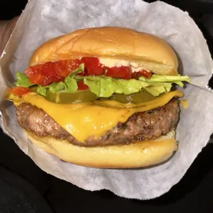 Veggie burger with cherry peppers, cheese, pickles, and lettuce.