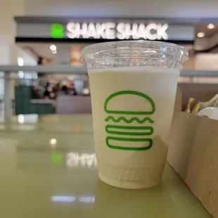 a drink in a plastic cup on a table