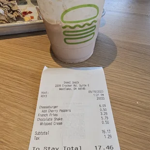 a receipt and a drink on a table