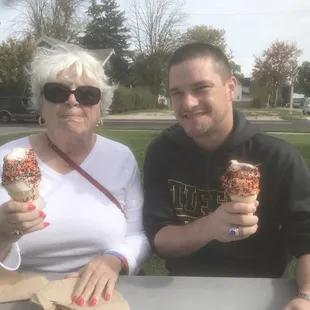 a man and a woman holding ice cream cones