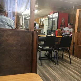 a man sitting at a table in a shake shop