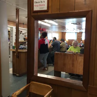 a reflection of a customer in a mirror