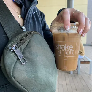 a woman holding a cup of coffee