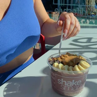 a woman eating a smoothie