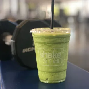 a green smoothie in a plastic cup