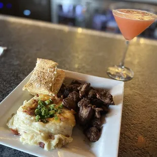 Steak bites, loaded mashed potatoes and my upside down pineapple martini after I stirred it up