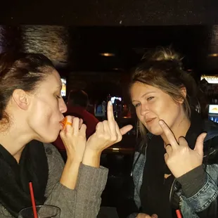 two women making a peace sign