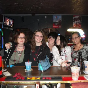 a group of women sitting at a bar