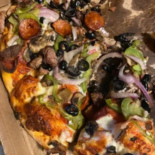 Half eaten combination pizza